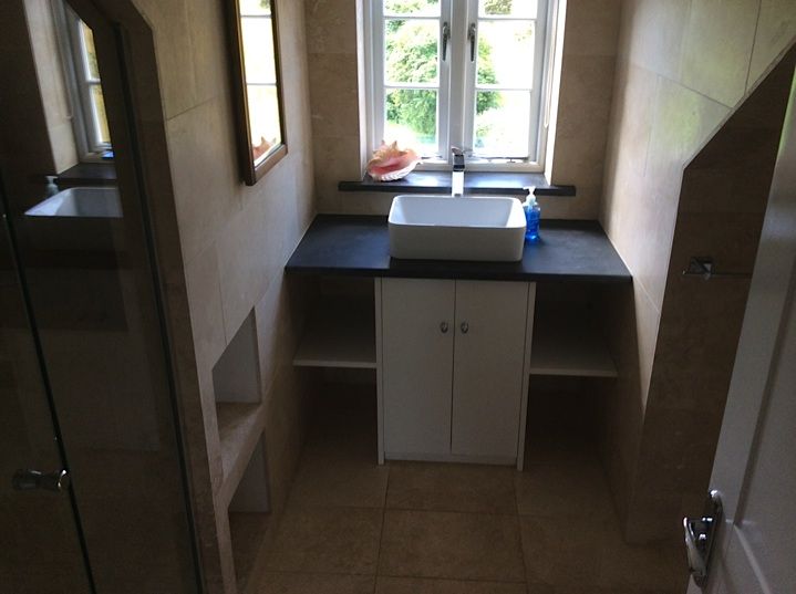 Bathroom with a basin beneath a window