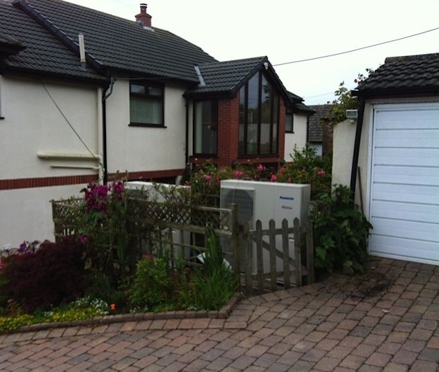 Air source heat pump beside a North Devon house